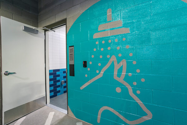 Entrance to dog wash station with large painted wall graphic.