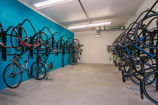 Bike storage room with racks of hanging bikes.