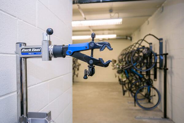 Detail of bike repair stand with bike storage room behind.