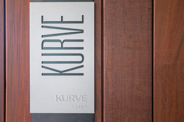 Detail of door placard at entrance to Kurve room.