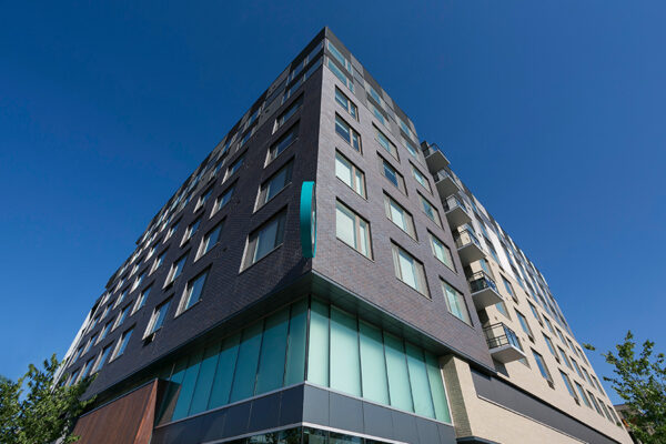 Exterior of 7 S Denver Haus apartments showing modern architecture and brick construction.