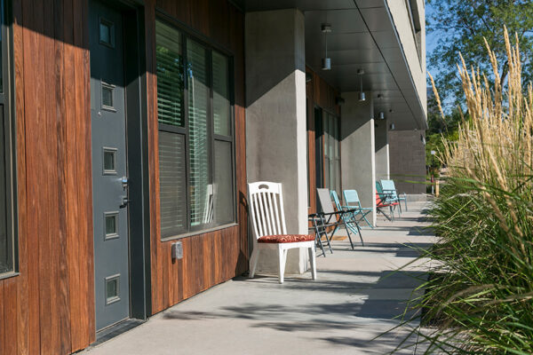 Apartment patios outside 7 S Denver Haus with outdoor furniture and decorative doors.