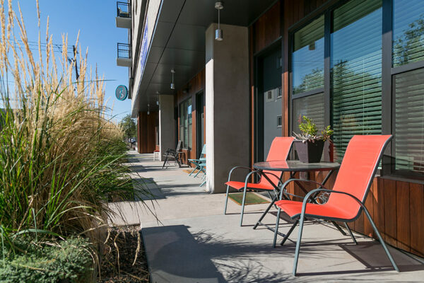 Apartment patios outside 7 S Denver Haus with outdoor furniture and decorative doors.
