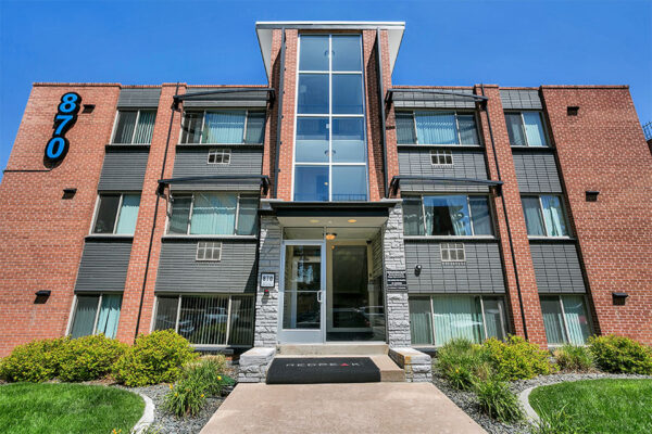 870 Cherry building with glass entrance doors and lush landscaping.