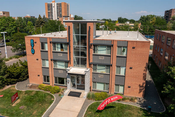 Aerial view of 870 Cherry building with brick construction and grassy lawn.