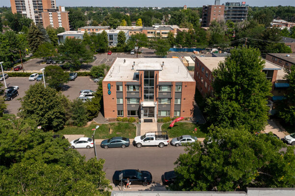 Aerial view of 870 Cherry building with brick construction, grassy lawn, and street parking.
