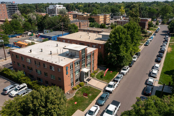 Aerial view of 870 Cherry building with brick construction, grassy lawn, and street parking.
