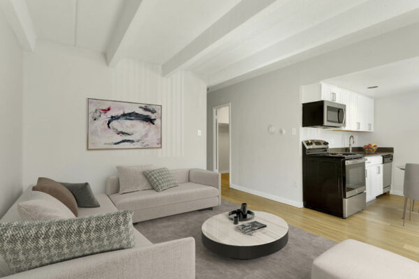 Image of furnished living room leading into kitchen and dining area