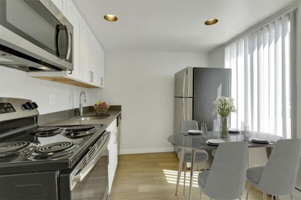 Image of kitchen and dining area with appliances and natural light