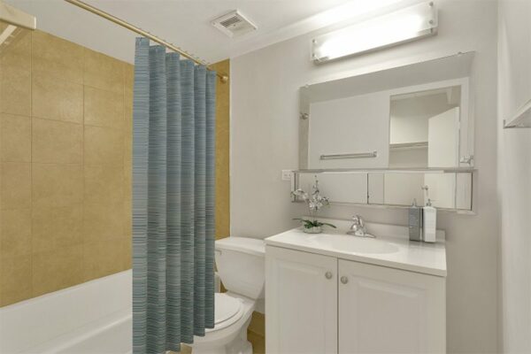 Image of bathroom with shower curtain and white furnishings