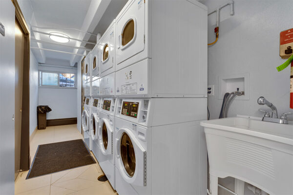 Laundry room with stacked washers and dryers.