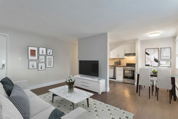 Living room with wood floor, modern furniture, and dining table.