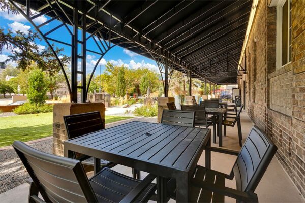 Tables under shade awning outside 960 Grant.
