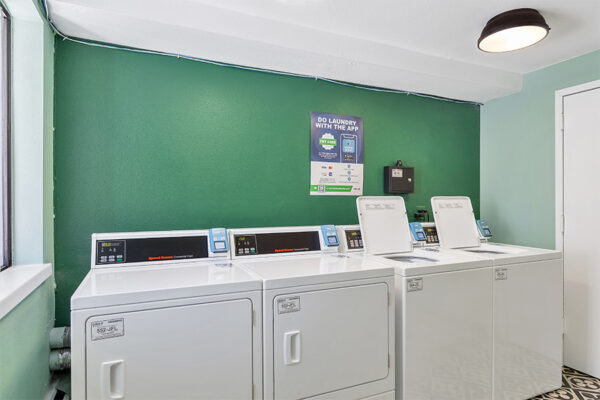 Laundry room with washers and dryers.