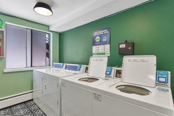 Laundry room with washers and dryers.