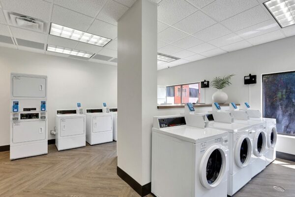 Laundry room with wood floor and washing machines.