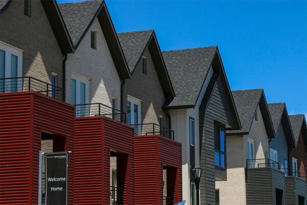Dayton Station townhomes with three story brick construction and red metal siding.