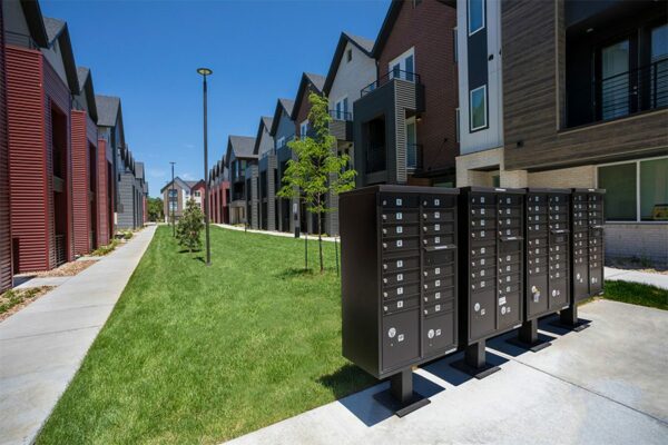 Dayton Station townhomes mailboxes and courtyard with lush lawns and newly planted trees.