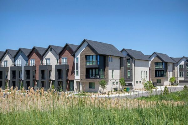 Dayton Station townhomes surrounded by tall grass and open space.