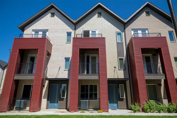 Dayton Station townhomes with red metal siding and balconies.