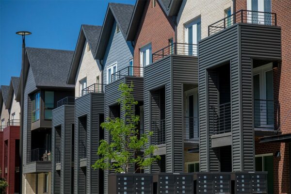 Dayton Station three story townhomes with balconies and colorful siding.