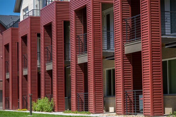 Dayton Station townhomes with red metal siding and balconies.