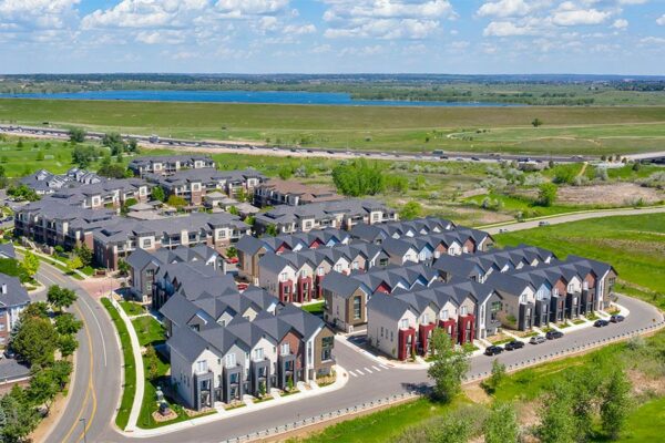 Aerial view of Dayton Station townhomes surrounded by open space with distant lake.