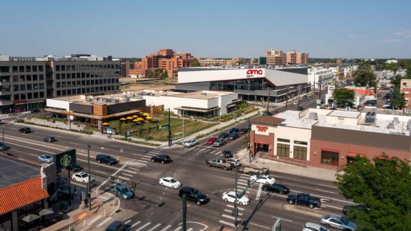 Aerial view of intersection with Trader Joes, AMC theater, and Postino restaurant.
