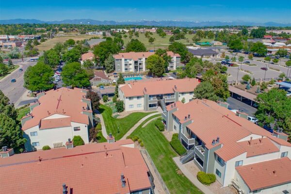 Aerial view of Hadley apartments with lush green lawns and tall trees.