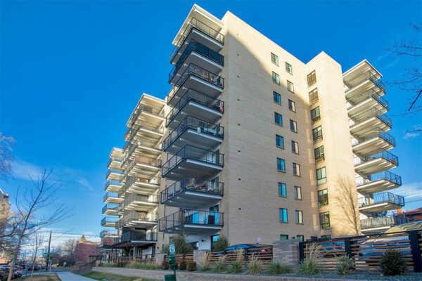 Story apartments with blonde brick construction, large balconies, and ample parking.