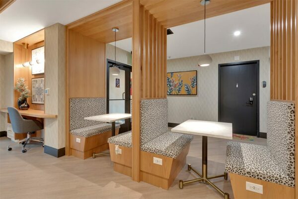 Lounge with modern wood booths and desk space.