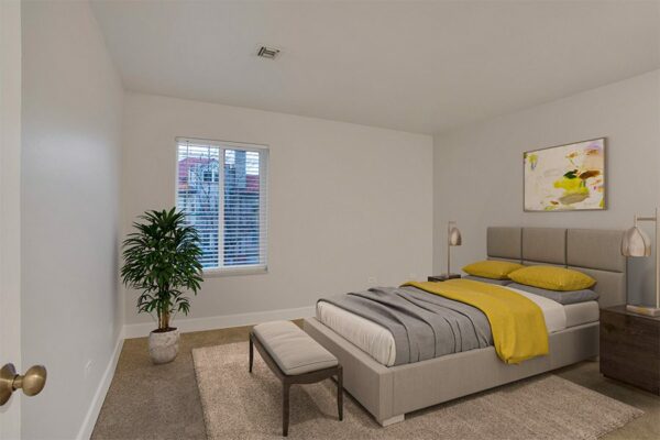 Bedroom with carpet, large bed with plush headboard, modern bedside tables with lamps, and large window.