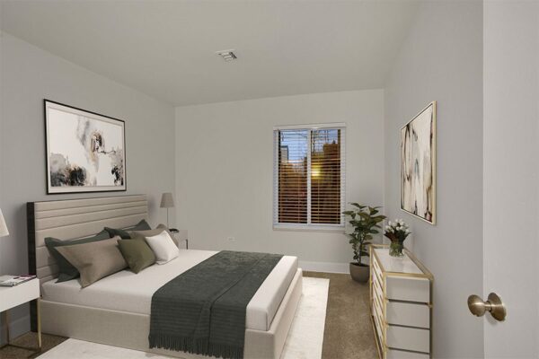Bedroom with carpet, bed with plush headboard, modern bedside tables with lamps, and modern dresser.