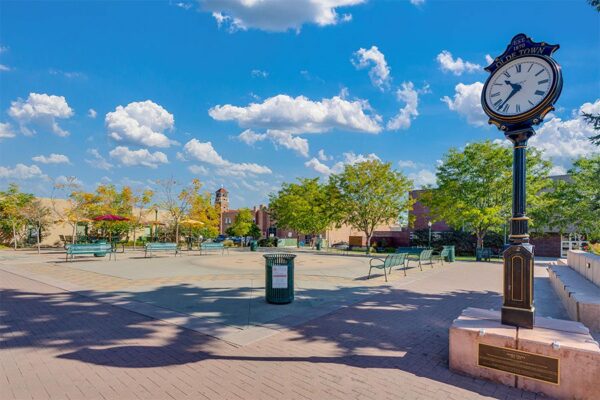 Olde Town Arvada square with seating and clock.