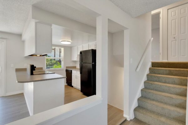 staircase, kitchen, and hallway view