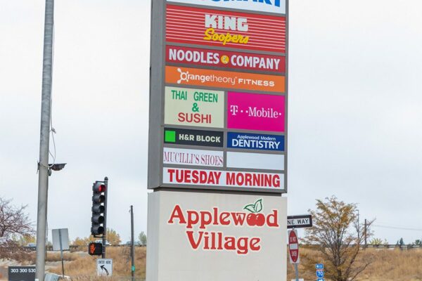 Applewood Village shopping center signage advertising Tuesday Morning, King Soopers, Noodle & Company, and more.