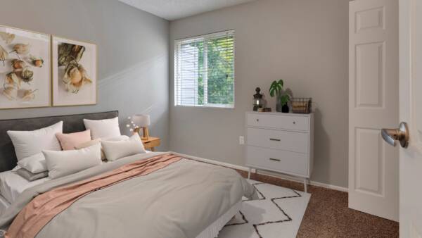 bedroom with bed, large window, and dresser