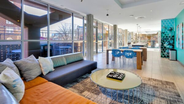 Community room with couches, kitchen seating and tv.