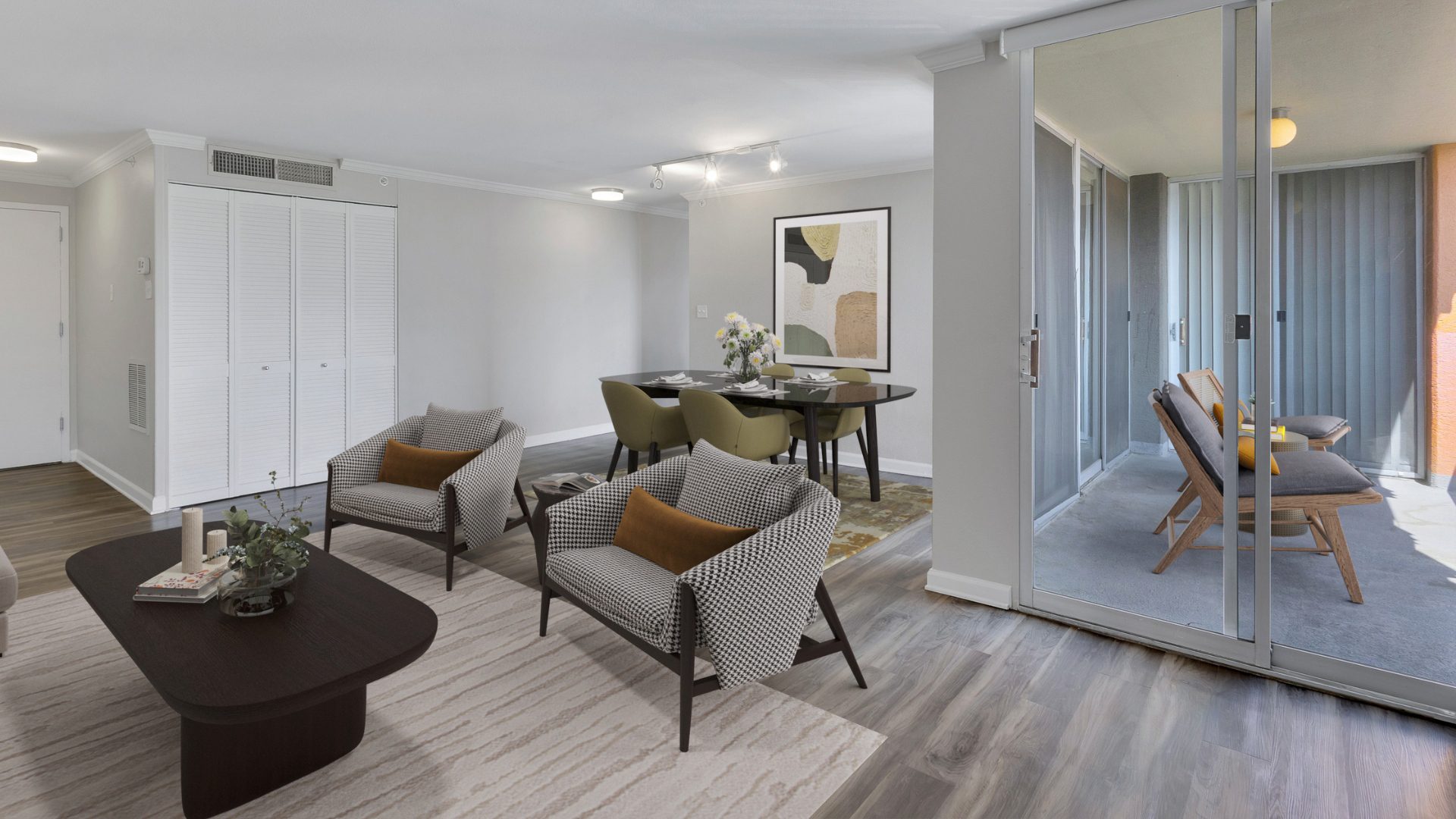 living room with couch and chairs and entrance to the balcony