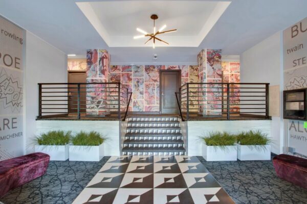Entryway with cartoon wall paper and vibrant colors with stairwell