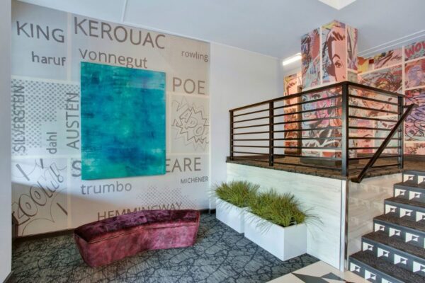 Entryway with cartoon wall paper and vibrant colors with stairwell