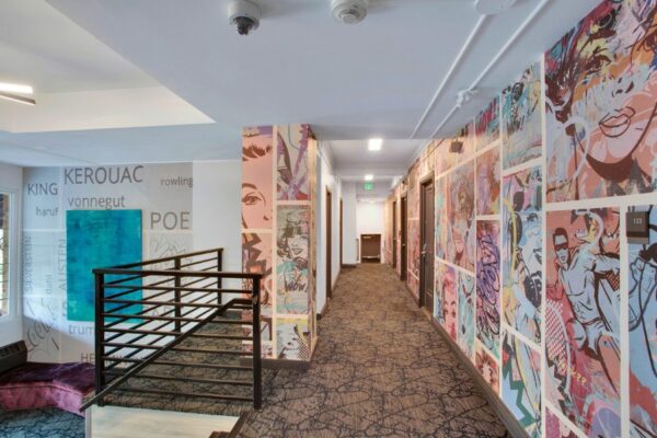 Entryway with cartoon wall paper and vibrant colors with stairwell