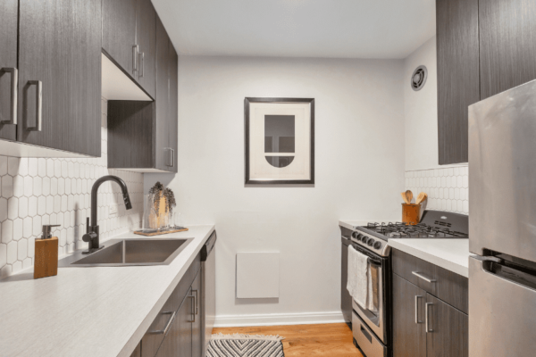 Kitchen with stainless steel appliances and white tile back splash