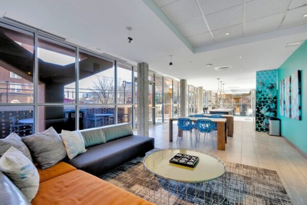 Community room with couches, kitchen seating and tv.