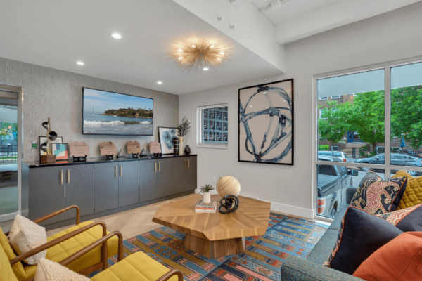 resident lounge with couches, tv, and large windows