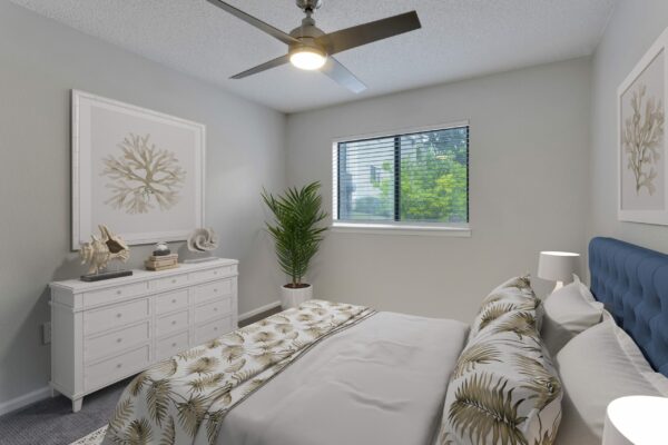 Bedroom with plush bed, dresser with eclectic decor, framed artwork, and ceiling fan.
