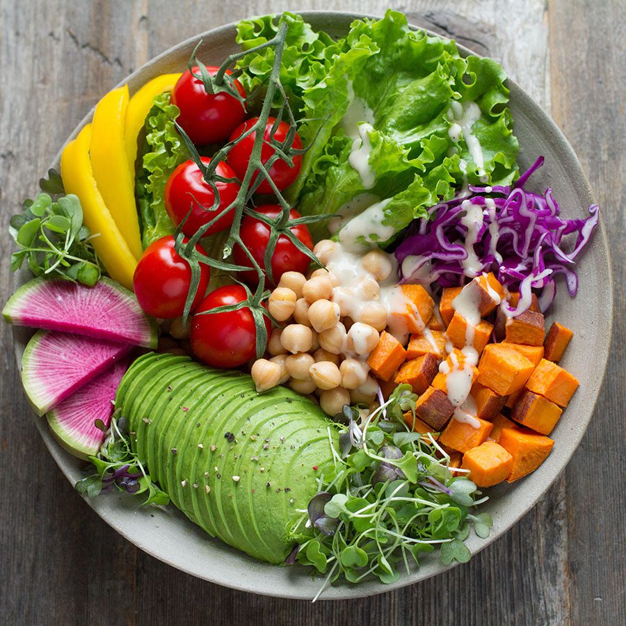 Detail of salad with avocado, tomatoes, sweet potatoes, and Garbanzo beans.