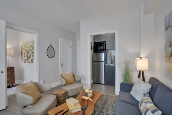 studio apartment with couch, bed and kitchen