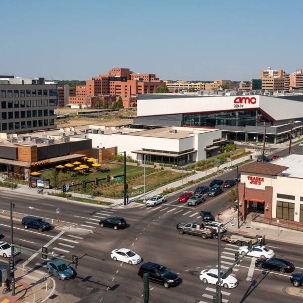 Aerial view of intersection with Trader Joes, AMC theater, and Postino restaurant.