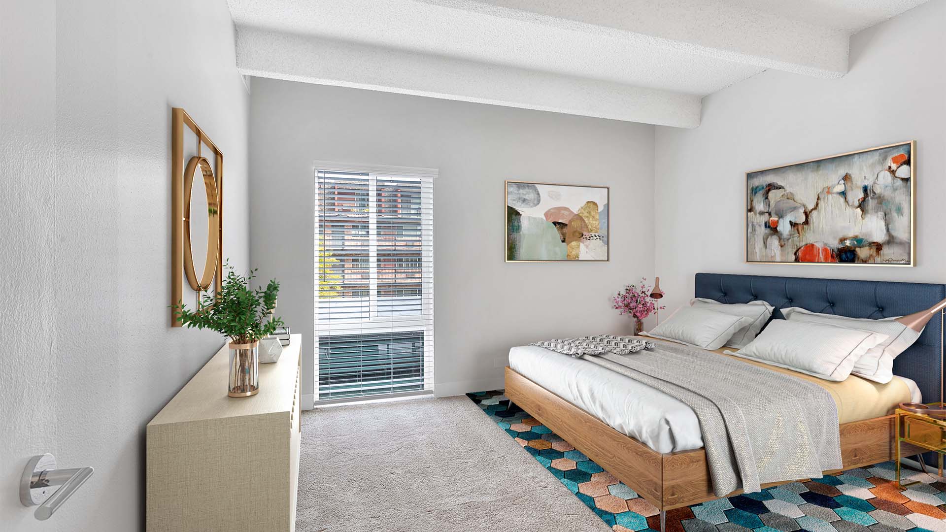 Bedroom with carpet, geometric rug, bed with plush headboard, artwork, and large window.